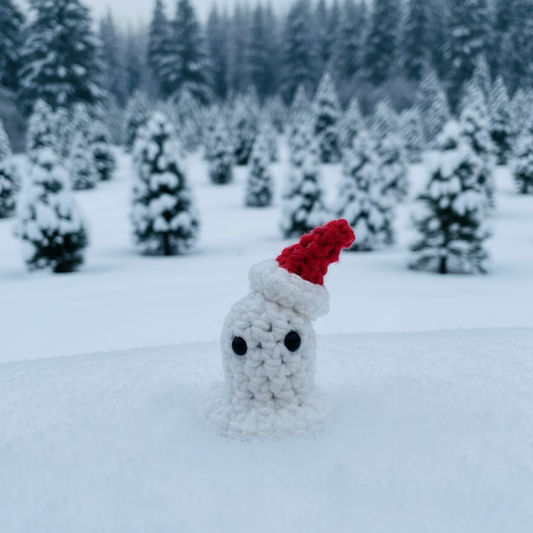 Small crocheted ghost in a santa hat in a snowy landscape