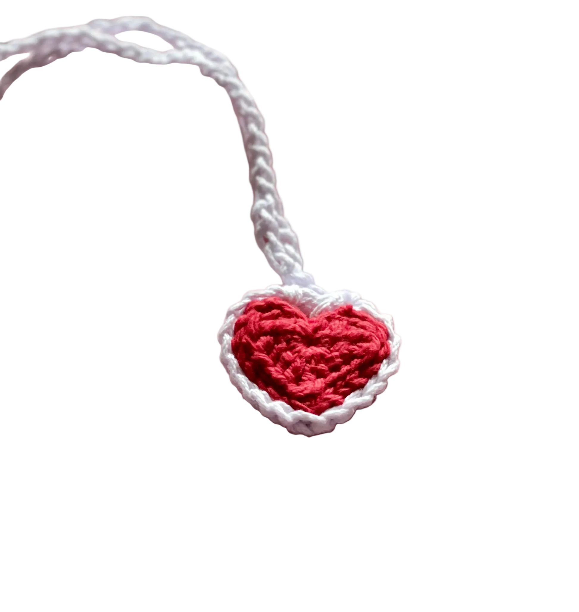 A crocheted red heart with white lace on a white crocheted pendant