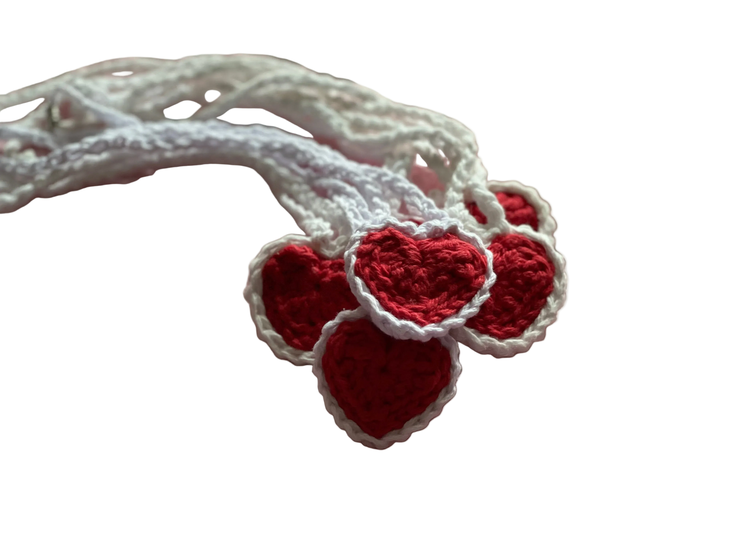 Crocheted red hearts with white lace on white crocheted pendants