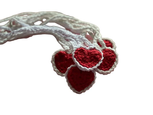 Crocheted red hearts with white lace on white crocheted pendants